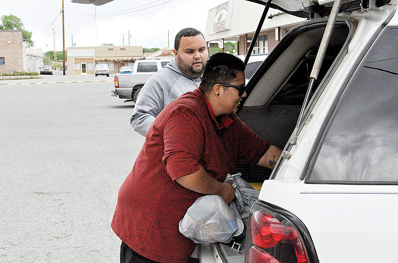 Monica Velasquez handing out food